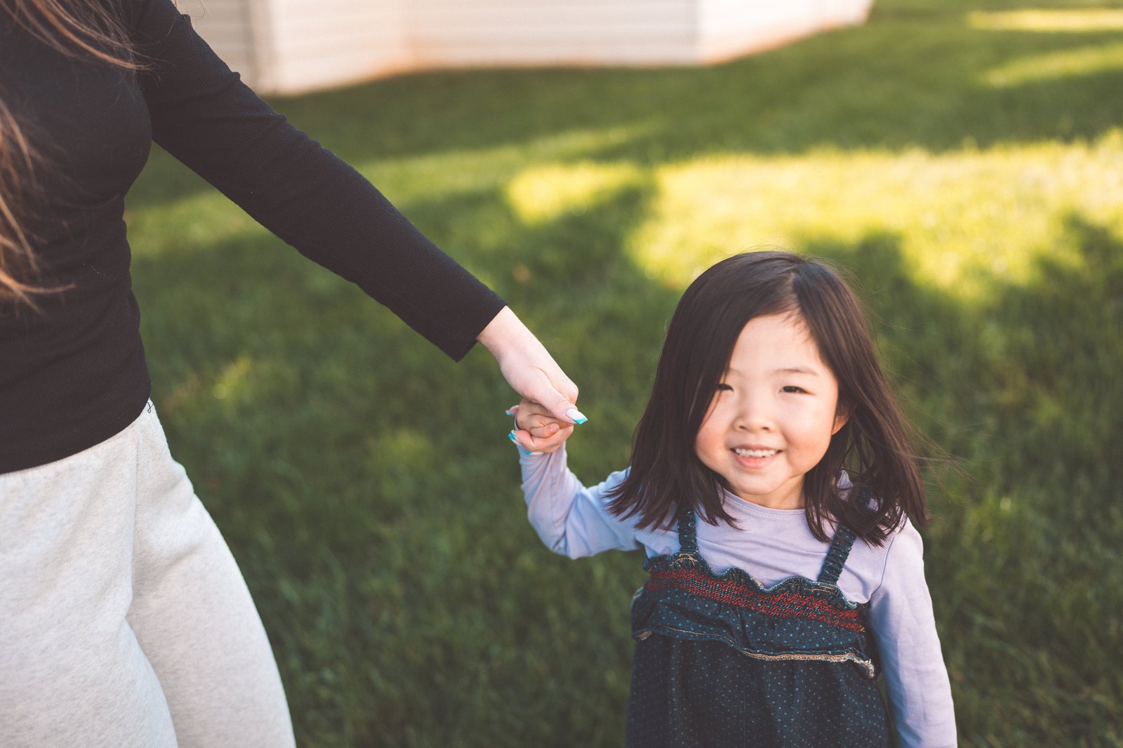 A child at Eliane's, hand in hand